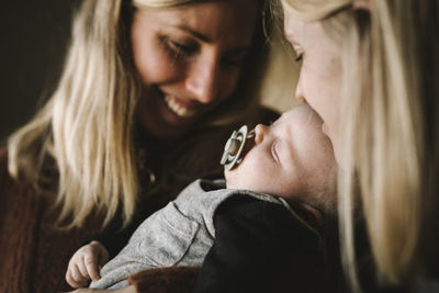 Mothers holding sleeping newborn baby