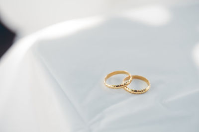 Close-up of wedding rings on table