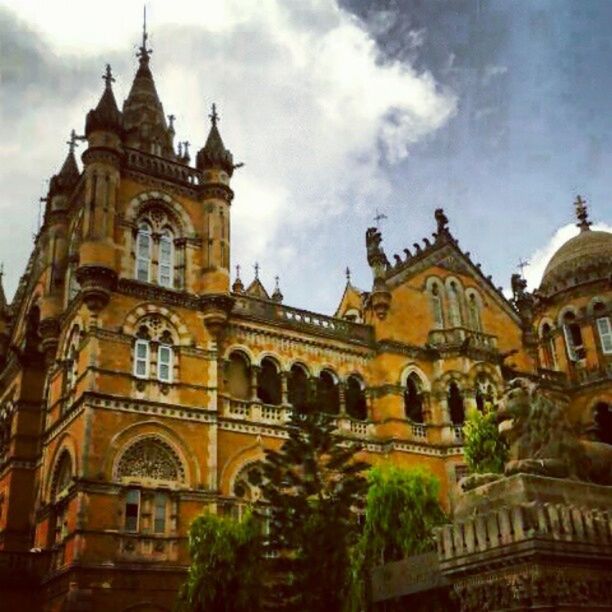 architecture, building exterior, religion, place of worship, church, built structure, spirituality, low angle view, sky, cathedral, facade, cloud - sky, travel destinations, history, famous place, outdoors, cross, no people