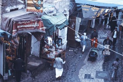 High angle view of people at street market in city