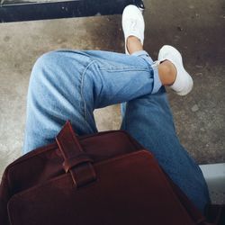 Low section of woman sitting in city