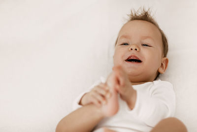 Portrait of cute baby on bed