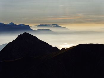 Scenic view of mountains against cloudy sky