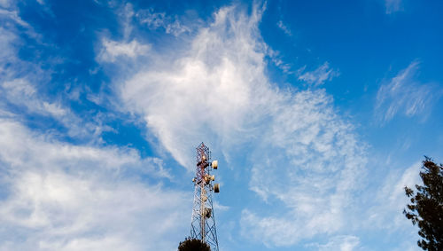 Low angle view of telephone tower against blue sky