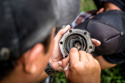 Cropped image of man cleaning vehicle part