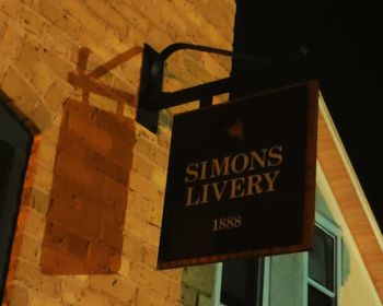 Low angle view of information sign at night