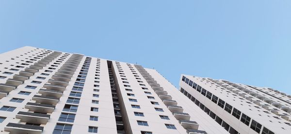 Low angle view of modern building against clear blue sky