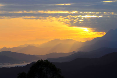 Scenic view of silhouette mountains against sky at sunset