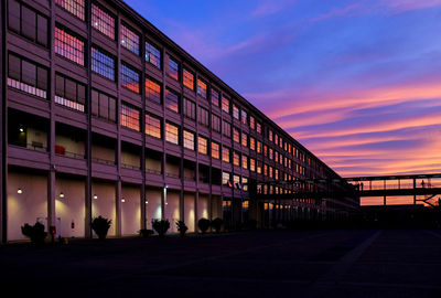 Illuminated building against sky at night