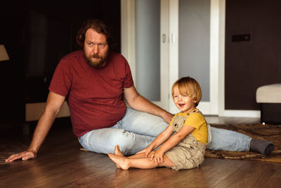 Dad with little son playing on the floor