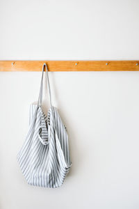 Close-up of clothes hanging against white wall