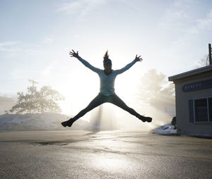 Young woman against sky