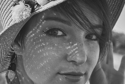 Close-up portrait of woman wearing hat