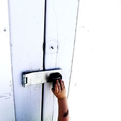 Close-up of human hand on door