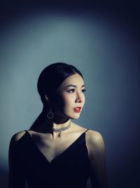 Beautiful woman standing against wall