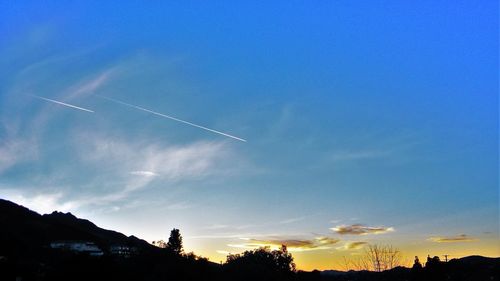 Low angle view of vapor trails in sky