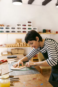 Shoemaker working on template in her workshop