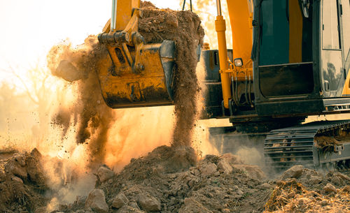 Close-up of excavator at construction site. backhoe digging soil for earthwork and construction
