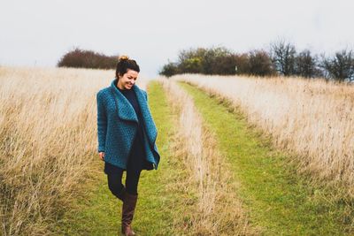 Woman standing on grassy field