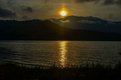 Scenic view of lake against sky during sunset