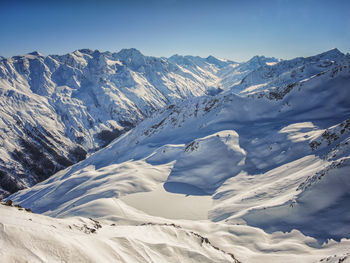 Scenic view of snowcapped mountains against sky