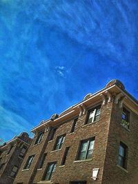 Low angle view of building against blue sky