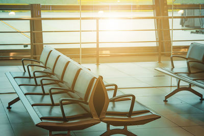 Empty chairs and tables in tiled floor