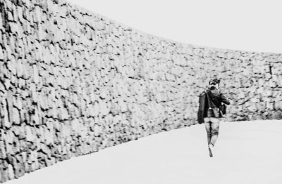 Full length of woman standing by railing