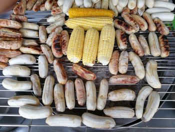 High angle view of bananas and sweetcorn on barbecue grill