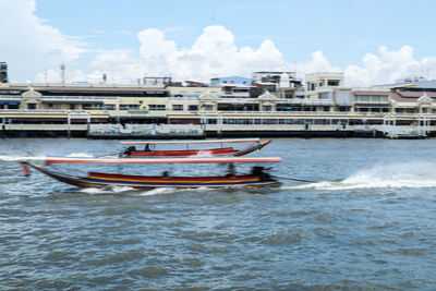 Boat moored in sea against sky