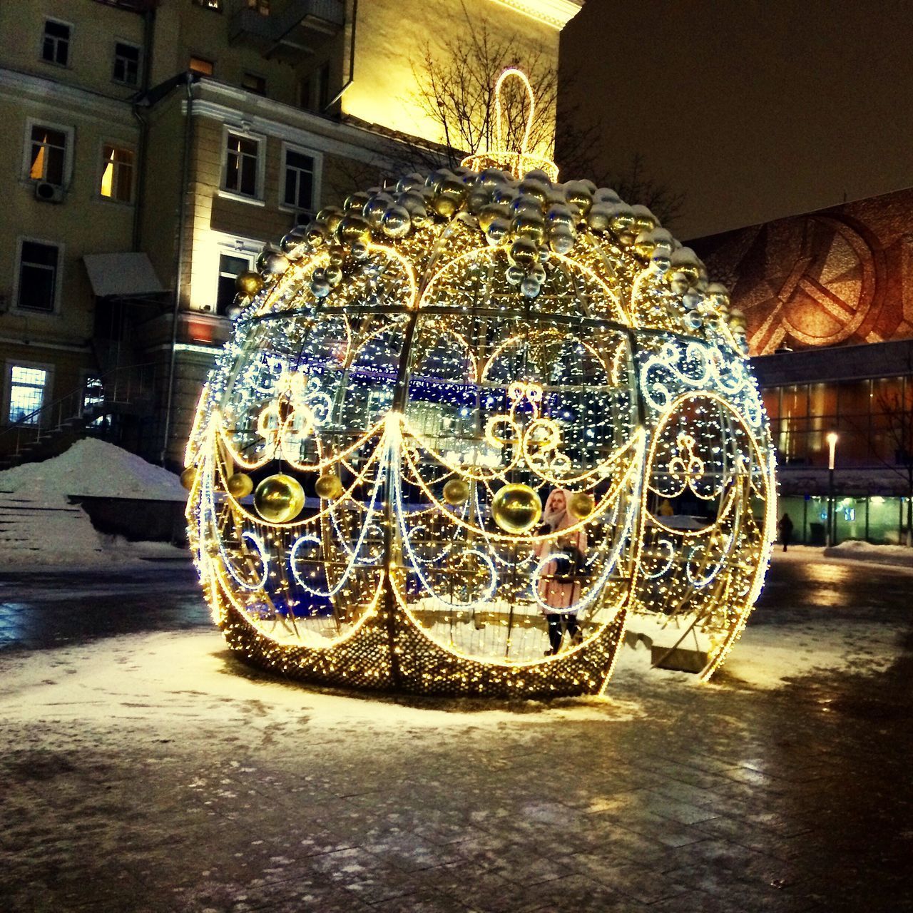 CLOSE-UP OF ILLUMINATED LIGHTING EQUIPMENT ON STREET AGAINST BUILDING