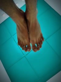 Low section of woman legs in swimming pool