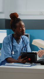 Nurse talking with patient in clinic