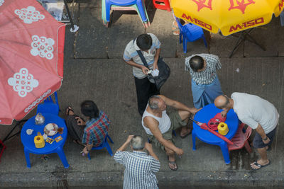 High angle view of men at sidewalk cafe