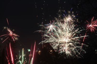 Low angle view of firework display at night