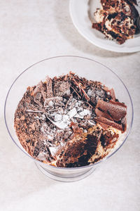 Pot of irresistible layered billionaires dessert made from mousse, belgian chocolate sauce