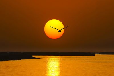 Scenic view of sea against orange sky