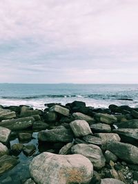 Rocks in sea against sky