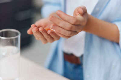 Midsection of man holding drink