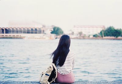 Rear view of woman looking at river