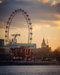 Ferris wheel against cloudy sky