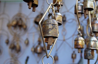 Close-up of old bell hanging against wall