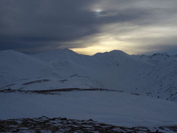 Scenic view of snow covered mountains against sky