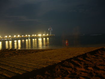 Illuminated bridge at night