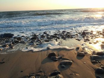 Scenic view of beach against sky during sunset