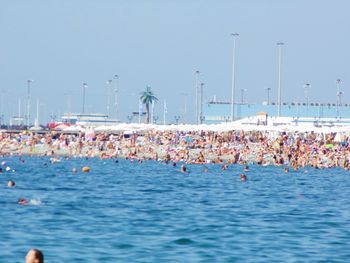 Boats in sea against clear sky