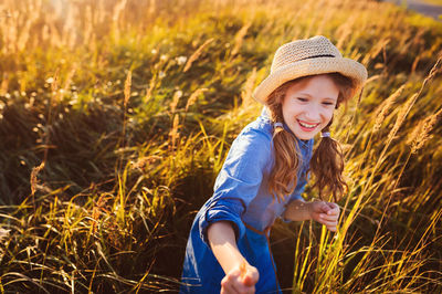 Smiling girl looking away against plants