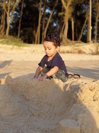 Cute little girl on sand at land