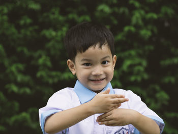 Portrait of smiling boy standing outdoors