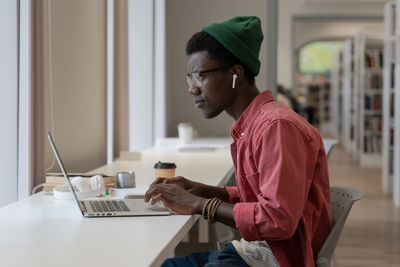 Side view of businesswoman working at office